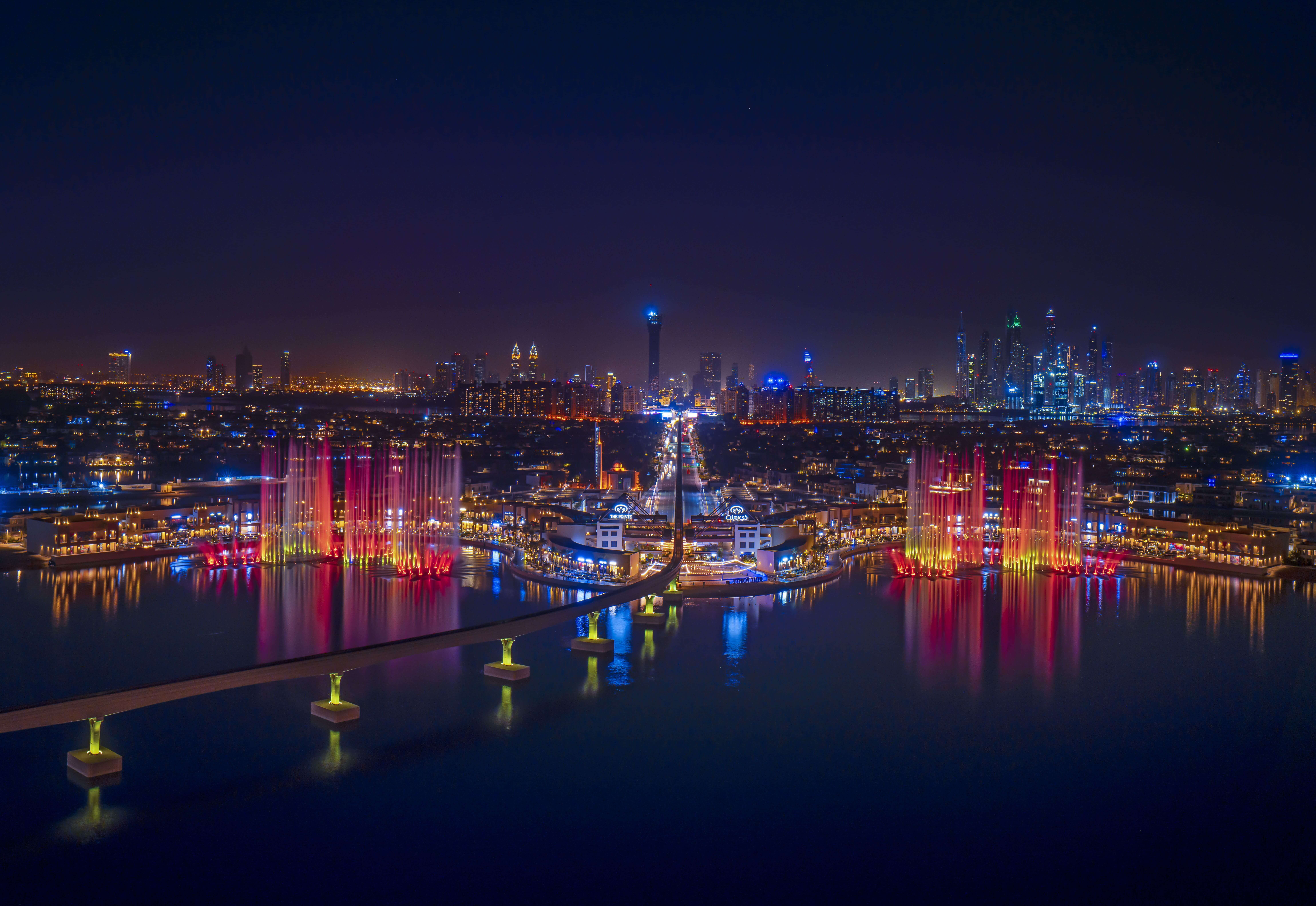 Palm Fountain's sea view from The Pointe's observation deck at night overlooking Dubai's skyline